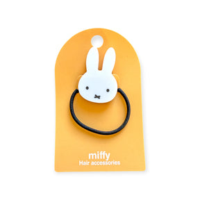 White Miffy Bunny charm attached to black hair tie on mustard yellow card, front view, gallery image one