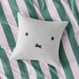 Light gray wool cushion cover with black Miffy-style face on a square pillow