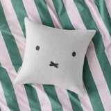 Light gray wool cushion cover with black Miffy-style face on a square pillow