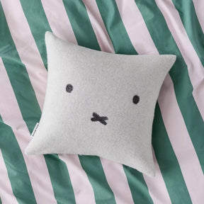Light gray wool cushion cover with black Miffy-style face on a square pillow