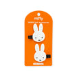 Orange package card showing two white bunny hair clip accessories with black snap clips