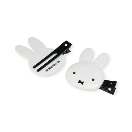 Two white bunny hair clips with black snap barrettes, one shows bunny face
