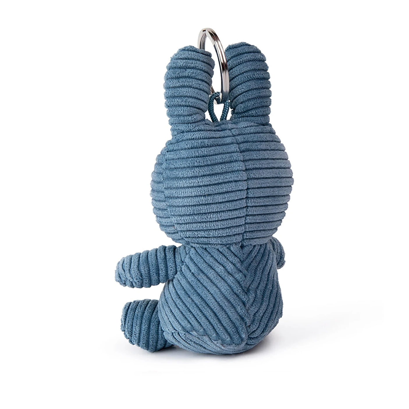 The Miffy Keychain Corduroy 10cm in Aviator Blue features a rear view of a corduroy rabbit keychain with a ring on top, echoing Miffy's charm.