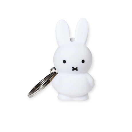 The Miffy Bunny Keychain - White, designed by Miffy, stands upright against a plain background, highlighting its minimalist style with its iconic bunny shape.