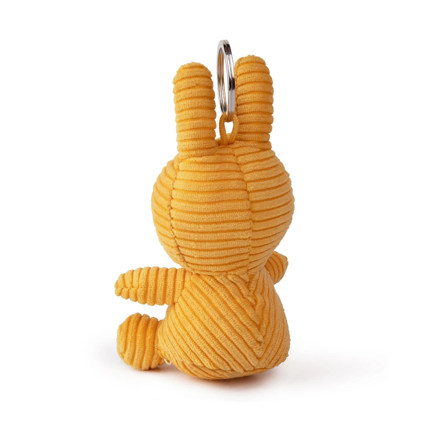 The Miffy Keychain Corduroy 10cm - Yellow features an adorable orange bunny sitting upright and facing away, accented with yellow. A metal ring on top makes it a delightful accessory for your bag or keys.