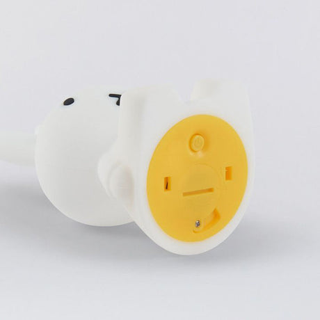 Close-up of the back of a white plastic Miffy Bunny Night Light (15cm) with a yellow battery compartment cover, featuring a screw and slot for opening, similar to a cat nightlight.