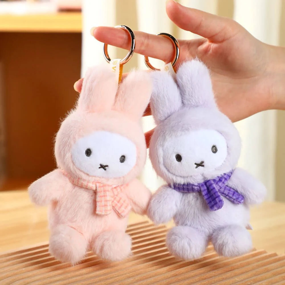Light pink and purple plush rabbit keychains with gold keyrings and plaid scarves.