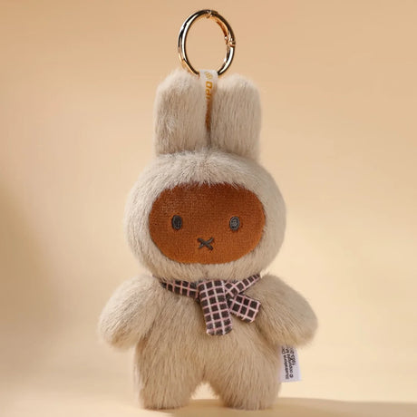 The Miffy VIPO x Miffy Macaron 2 Plush Keychain - Blind Box features a bunny-shaped pastel plush with cream fur, brown face, black eyes and nose, plus a checkered scarf, displayed on a beige background.