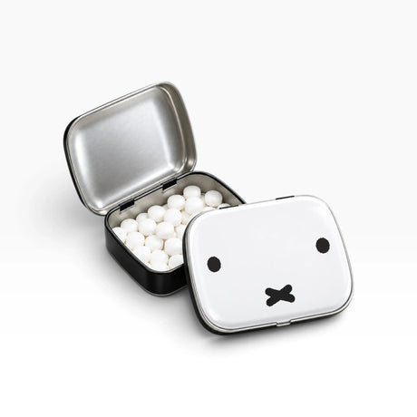 Miffy bunny pill tin open, showing white tablets inside and bunny face on lid