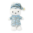 The Miffy Bunny Pyjama Plush - 24cm is an eco-friendly stuffed toy rabbit dressed in a blue nightcap and pajamas adorned with stars and moons, standing upright. This delightful plush from the Miffy brand is perfect for sleepovers, making bedtime both fun and cozy.