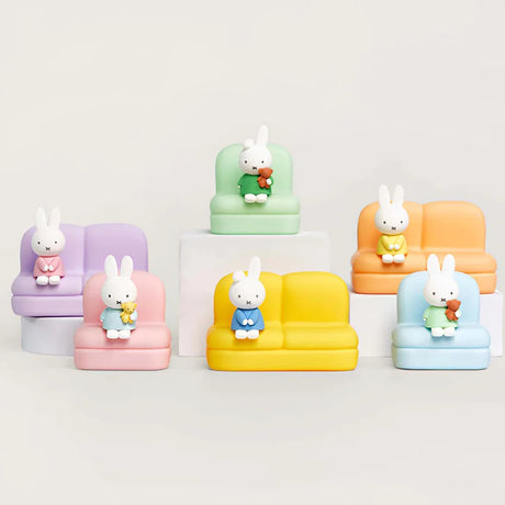 Six Miffy figures in colorful outfits seated on pastel mini sofas arranged on white platforms with neutral background