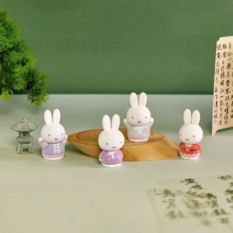 Four 6cm Miffy figures wearing pastel ancient-inspired costumes displayed with traditional calligraphy and bonsai background