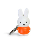 Introducing the Miffy Keychain - Classic by Miffy, a charming accessory featuring a white cartoon rabbit dressed in her iconic red outfit, standing upright against a simple white background.