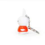 The Miffy Keychain - Classic by the brand Miffy showcases a white rabbit wearing a timeless red outfit, facing left against a white background, making it an adorable addition to any collection.