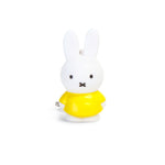 The Miffy Keychain - Classic features a white bunny figurine wearing a yellow shirt, showcasing the charm of timeless colors against a plain white backdrop.