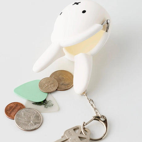 White Miffy keychain coin pouch made of soft silicone, holding coins and attached to a metal keyring.