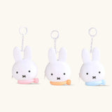 Set of Miffy bunny coin pouch keychains, white plush bunnies with key rings and colorful bases.