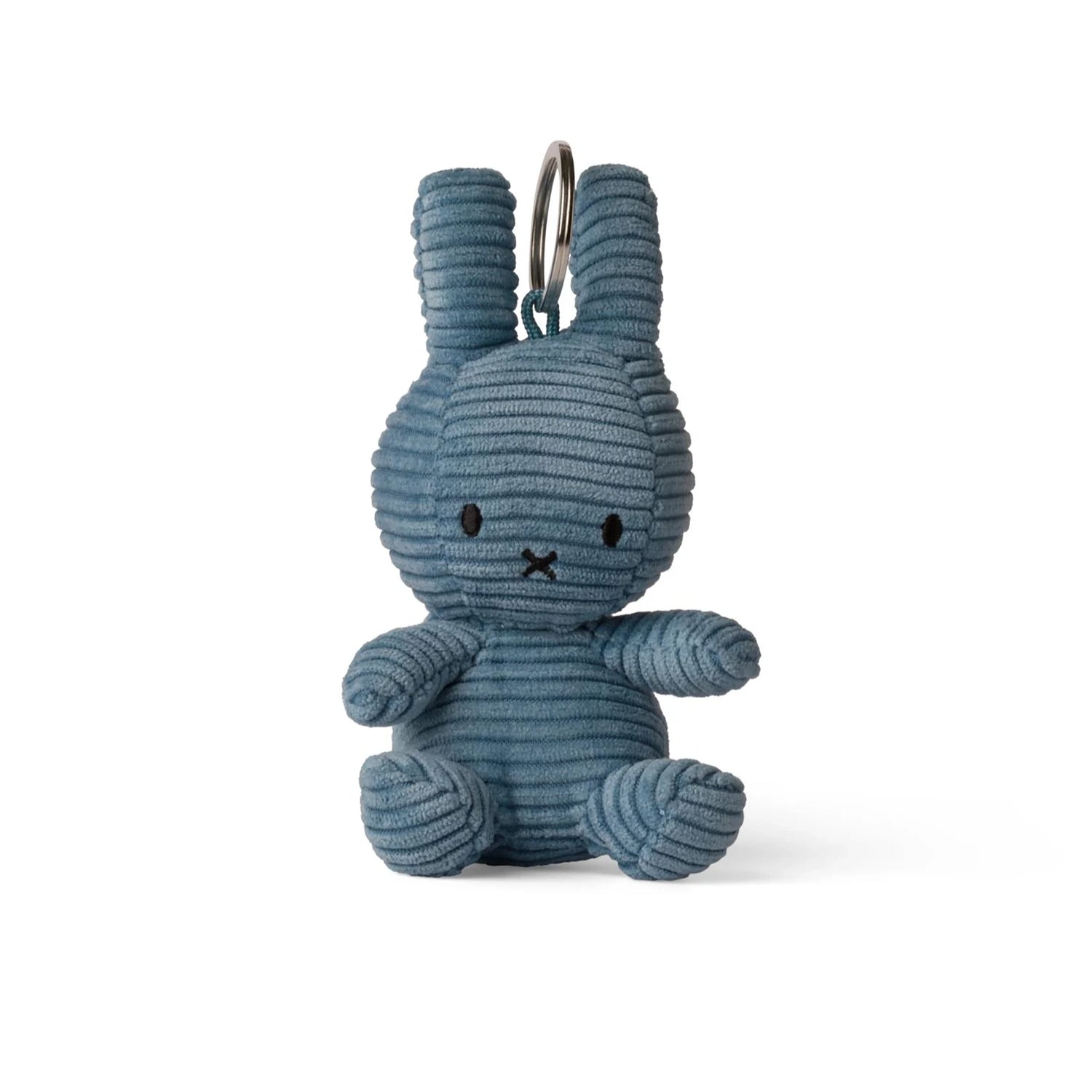 A small, eco-friendly Miffy Keychain Corduroy (10cm) shaped like a rabbit with aviator blue textured corduroy stripes and a round metal ring at the top, reminiscent of a classic Miffy plush charm.