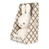 The Miffy Quilted Plush Gift Box - Cream 23cm, presented by Miffy, is crafted from quilted material and packaged in a diamond-patterned box labeled "the x label," featuring a tag that reads "100% recycled filling" to emphasize its eco-conscious design.