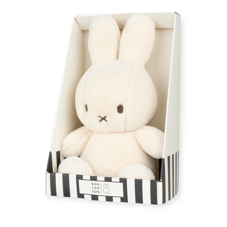 The Cozy Miffy Plush & Gift Box Cream - 23cm by Miffy features a plush bunny with long ears, made from super soft fabric, presented in an elegant white and black striped gift box.