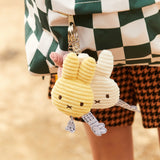 Cream corduroy bunny keychain with two stitched faces on a key ring