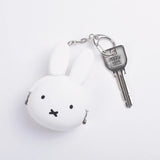 The Baby Miffy Keychain Purse by Miffy is a delightful accessory showcasing a round, white bunny face with ears, all secured to a metal key. This cute item also functions as a Japanese silicone purse, ideal for carrying small essentials.