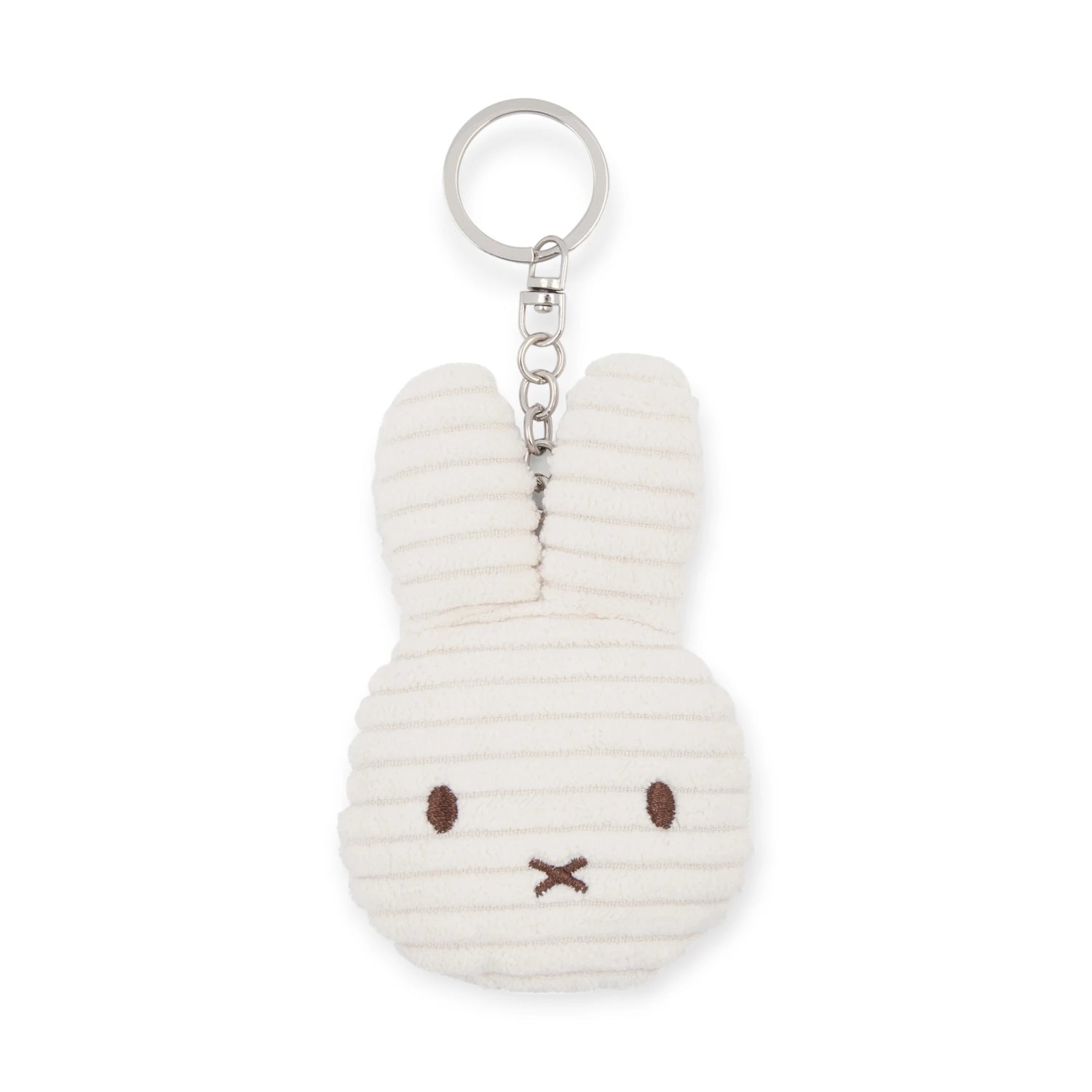The Miffy Flat Corduroy Keychain in off-white by Miffy is an eco-friendly accessory shaped like a rabbit's head with long ears, featuring brown stitched eyes and a mouth on textured striped fabric.