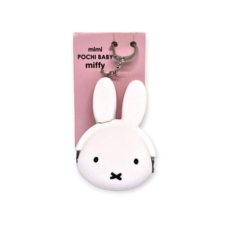 The Baby Miffy Keychain Purse, brought to you by the Miffy brand, is crafted from soft Japanese silicone and features Baby Miffy's signature ears and minimalist face. This delightful white coin purse seamlessly combines style with functionality for storing small essentials.