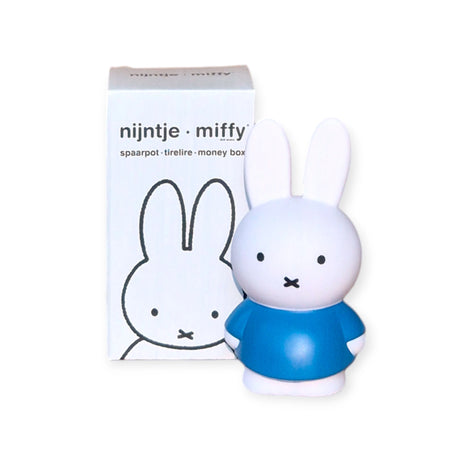 The Miffy Bunny - Blue Money Box 12cm, crafted by the brand Miffy, sits elegantly beside its packaging adorned with the same delightful bunny design. This charming decorative item enhances any space while promoting early money management skills.