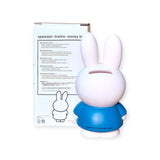 The Miffy Bunny - Blue Money Box 12cm, from the Miffy brand, is a delightful blue and white bunny-shaped money box accompanied by its packaging that includes instructions and a coordinated bunny design. This decorative item not only enhances any living space but also encourages financial skills for individuals of all ages.