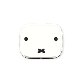 Small white rectangular pill tin with minimalist Miffy bunny face featuring two dots and an X on white background