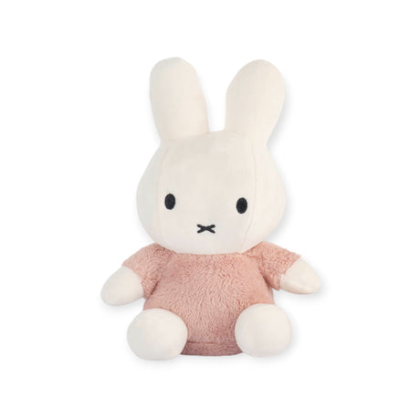 Miffy Plush Fluffy Plush Pink - 25cm: This delightful Miffy plush features a charming white rabbit with long ears and black eyes, dressed in a soft, fluffy pink outfit. It makes the perfect addition to nursery decor, sitting sweetly against a plain white background.