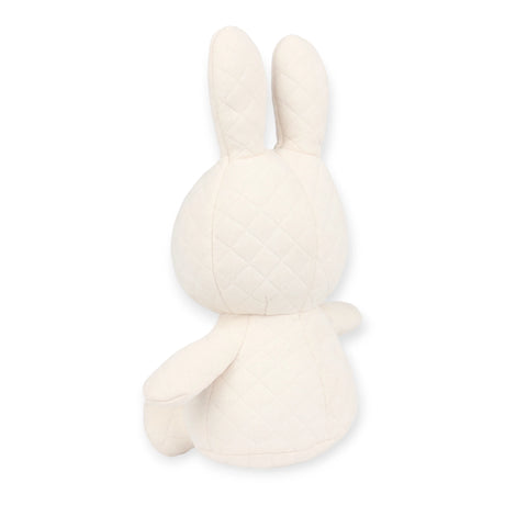 The Miffy Quilted Plush Gift Box in cream, measuring 23cm, displays the handcrafted quilted texture of the Miffy brand bunny plush from a rear angle, set against a simple white backdrop.