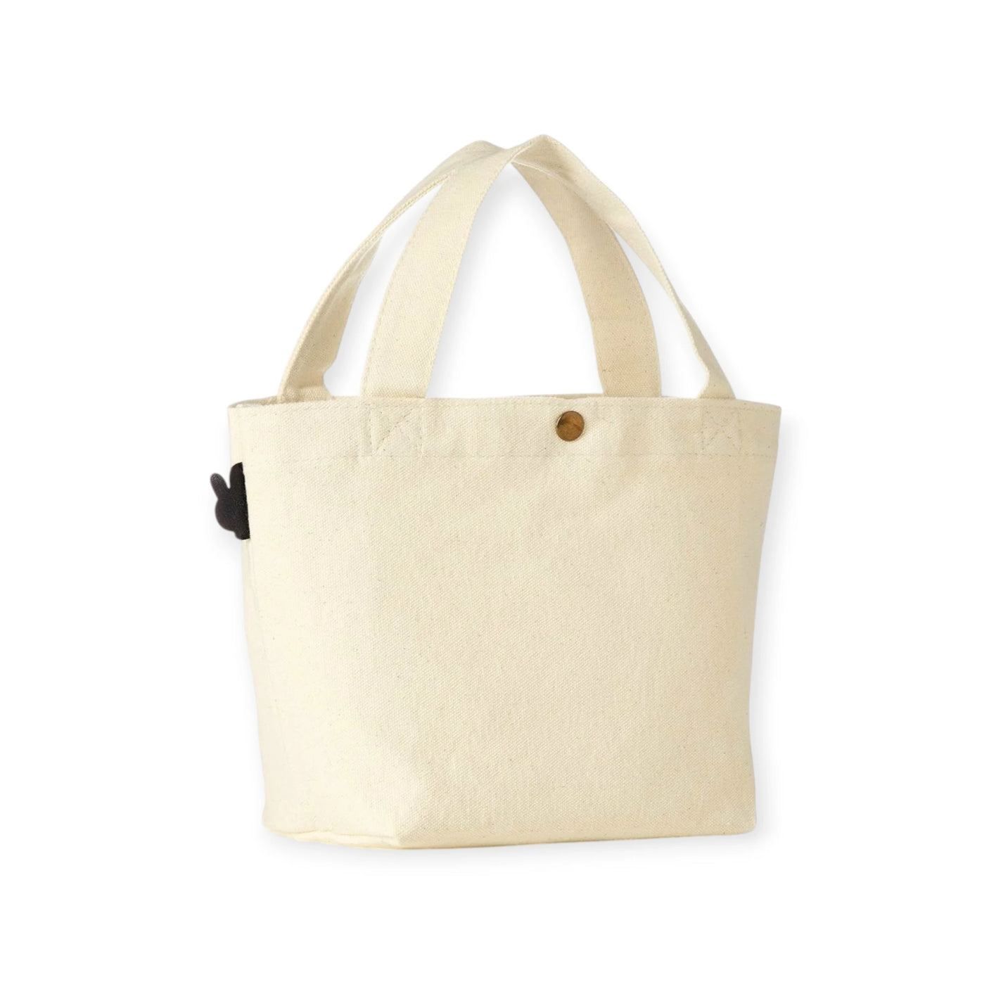 The Miffy Small Canvas Tote Bag, by Miffy, is an adorable cream-colored cotton canvas tote with short handles and a small black object attached to the side—ideal for carrying your essentials.