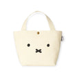 The Miffy Small Canvas Tote Bag, by Miffy, is an everyday essential crafted from classic cotton canvas with a minimalist face design featuring black cartoon eyes and a cross mouth. Its compact beige size makes it perfect for casual outings.