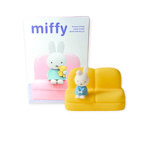 Mini yellow sofa stand featuring Miffy figure in blue outfit, with product box showing Miffy holding a teddy bear on pink sofa
