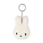 Introducing the Miffy Keychain Tiny Teddy Plush - Terry, a charming accessory from the Miffy brand. This eco-friendly keychain showcases a fluffy white bunny face with distinctive black eyes and a small black "X" for a mouth, all crafted from terry plush material and securely attached to a metal ring.