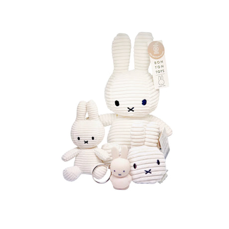 Four eco-friendly white plush bunny toys of different sizes, displayed on a pristine white background, include the Miffy Keychain Plush - Corduroy 10cm by the brand Miffy.