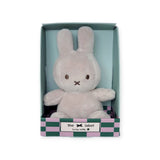 A Mini Miffy Plush bunny, known as the Grey Lucky Charm from the Miffy brand, comes nestled inside a green and pink checkered box labeled "Lucky Nifty," perfect for bringing a soft and cuddly vibe to your day.