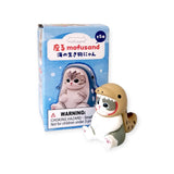 This Mofusand Premium - Aquarium Cat Blind Box showcases an adorable cat in a seal costume from the Mofusand series, ideal for any aquarium cat aficionado. Please note the warning label indicating that it contains small parts not suitable for children under 3 years.