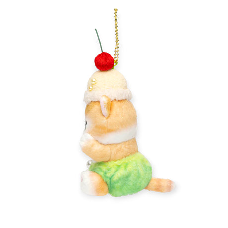 Side view of Cream Soda Nyan plush keychain with cream hat, green shorts, and cherry on top on a white background