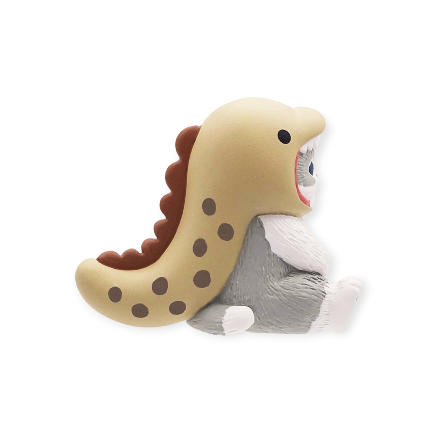 A small gray creature from the Mofusand Premium - Aquarium Cat Blind Box series, wearing a beige dinosaur costume with brown spots, sits against a white background. This adorable figure is perfect for any collector or fan of Mofusand surprises.