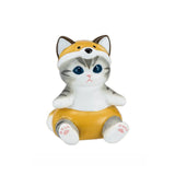 A charming Mofusand Mini Figure from the Vol 4 (Orange) collection showcases a ceramic figurine of a kitty in an animal-eared yellow costume, sitting with its paws visible.