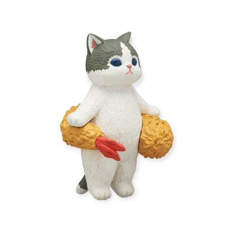 This delightful figurine from the Mofusand Premium - Fried Shrimp Cat Blind Box collection showcases a cat standing upright, holding a plush toy drumstick. With its gray and white fur, blue eyes, and design reminiscent of the Fried Shrimp Series by Mofusand, this collectible perfectly captures the essence of a cat's favorite food.