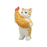 Included in the Mofusand Premium - Fried Shrimp Cat Blind Box, this charming figurine features a cat standing upright, lovingly holding a large piece of fried shrimp.