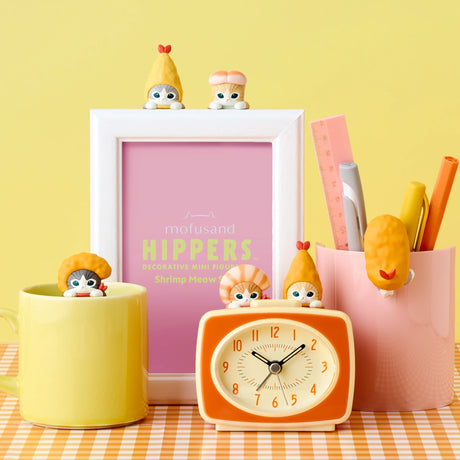 Multiple Hippers shrimp characters with red bow heads on desk items and clock