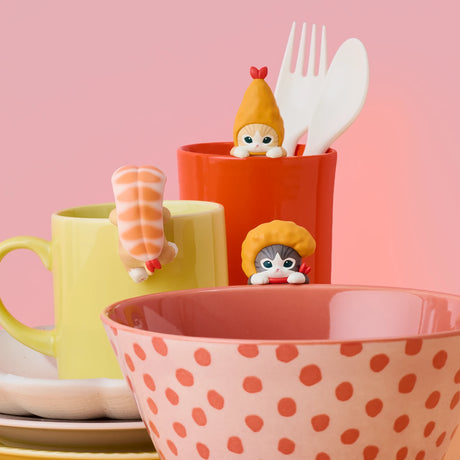 Hippers shrimp character figurines peeking from cups with utensils on a table