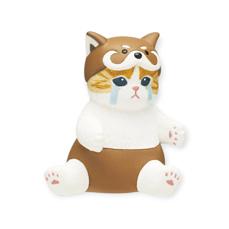 Complete your adorable Mofusand Premium - Nyanpantsu Blind Box collection with the delightful small figurine of a sitting cat in a brown and white dog costume, featuring tearful eyes. Part of the charming Nyanpantsu Series by Mofusand, collect them all!