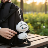 Panda plush keychain attached to backpack strap, white and black panda with teal eyes