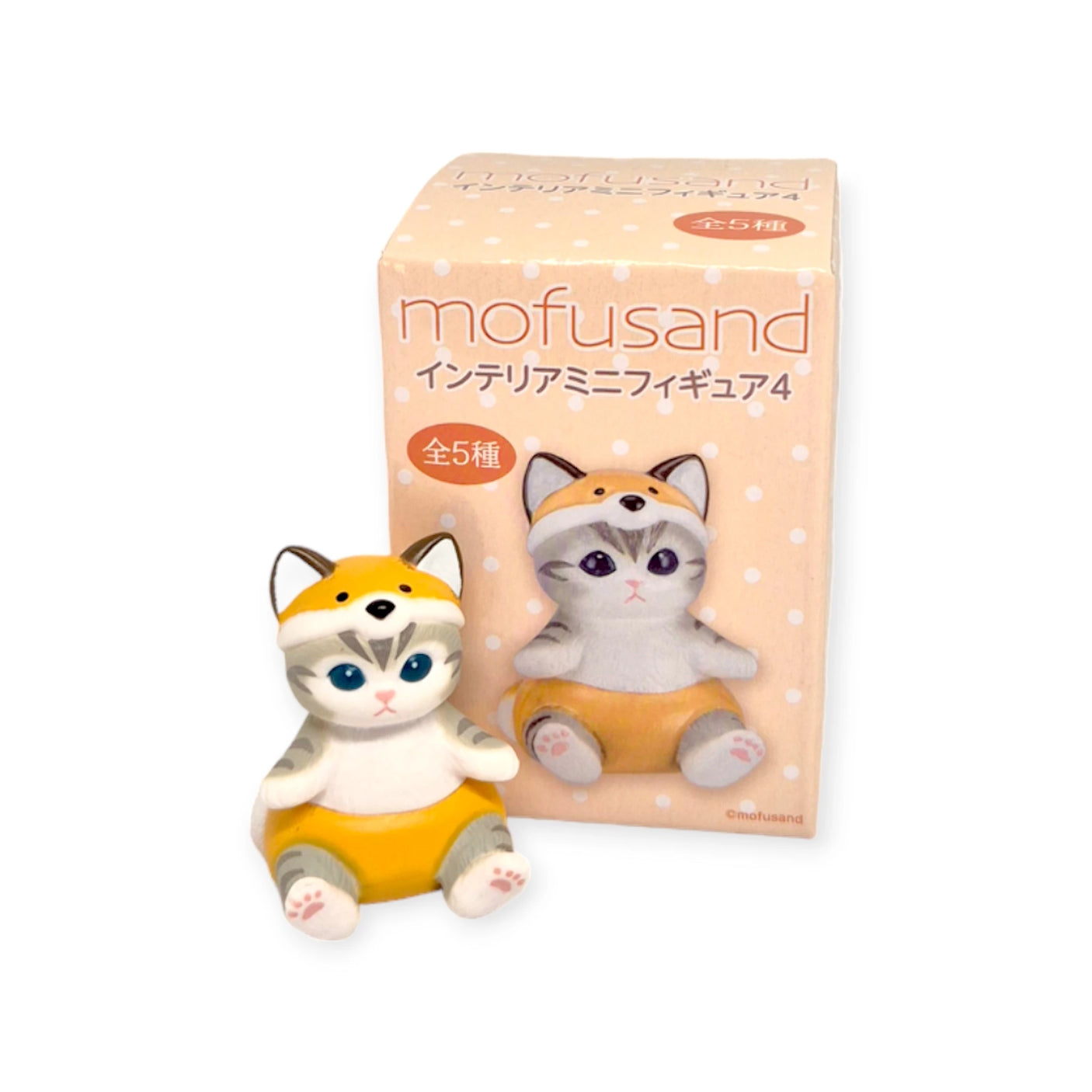 A charming kitty figurine dressed in an orange outfit is paired with a blind box featuring the same character, complete with "mofusand" text and Japanese writing, making it an adorable addition to the Mofusand Mini Figure Blind Box - Vol 4 (Orange) collection by Mofusand.